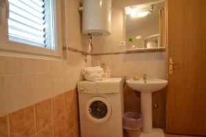 a bathroom with a washing machine and a sink at Big Dream 2 in Rovinj +13 photos