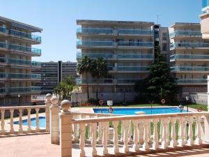 a swimming pool in front of a building at Familidays 010 Village Park in Salou