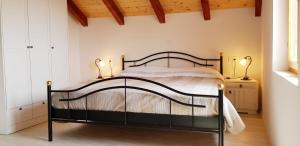 a bedroom with a black bed with two lamps at Villa Duboka, Otok Vis in Komiža