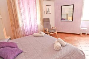 a bedroom with a large bed with towels on it at Garibaldi B&B in Cefalù