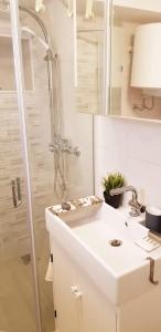 a white bathroom with a sink and a shower at Villa Duboka, Otok Vis in Komiža +23 photos