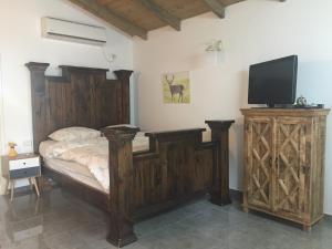 a bedroom with a bed and a tv on a cabinet at Hilltop Haven in Poriyya Illit