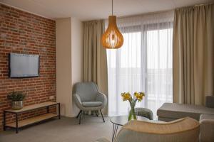 a living room with a couch and a chair at Appartementen Zeerust in De Koog