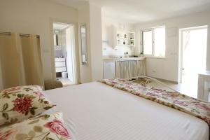 a bedroom with a white bed with flowers on it at PERE in Korčula