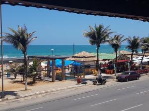 a view of a beach with palm trees and a street at Sol Praia Marina Hotel in Natal