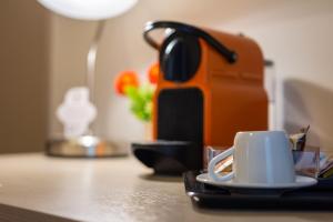 a coffee maker and a cup on a table at B&B Cairoli in Messina
