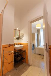 a bathroom with a sink and a bed at B&B Cairoli in Messina