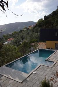 a swimming pool on top of a house at Villa Crassula in Casarza Ligure