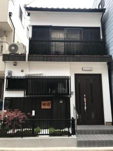 a building with a black door and a balcony at FUUTEI Japanese-style lodge in Kyoto
