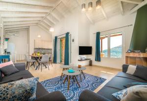 a living room with a couch and a table at Villa Emma in Sivota