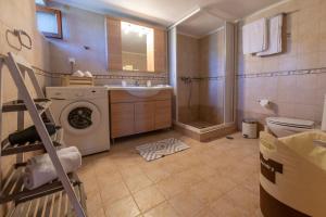 a bathroom with a washing machine and a sink at Madalena's Summer House in Adamantas +62 photos