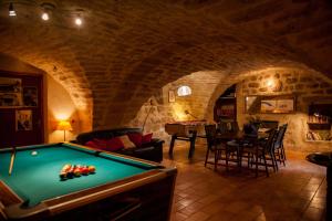 a living room with a pool table in a cave at Chambres d'Hôtes et Gîtes Le Mas Bleu & Spa Resort in Rosières