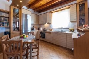 a kitchen with a table with a bowl of fruit on it at Madalena's Summer House in Adamantas