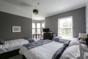 A bed or beds in a room at Baytree Lodge Chester 
