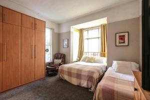 a bedroom with two beds and a window at Baytree Lodge Chester in Chester