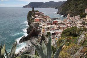 a village on a cliff next to the ocean at villa eolo in Vernazza