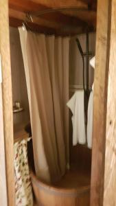 a room with a bed with a shower with a curtain at Parco Del Lago Glamping And Lodges in Anguillara Sabazia