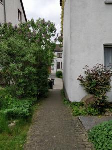 a walkway next to a white building with a bench at Apartment Nada in Kassel
