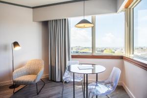 a room with a table and chairs and a window at HF Fénix Porto in Porto +15 photos