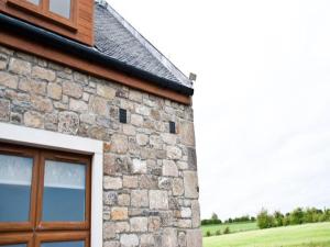 a stone building with a window on the side of it at Bamflatt Farm Bed & Breakfast in Strathaven