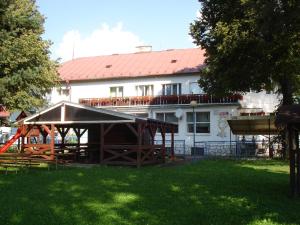 a house with a pavilion in front of a yard at Hotel Guľa in Batizovce