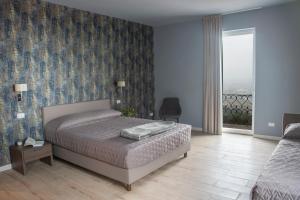 En eller flere senge i et værelse på Il Biotto