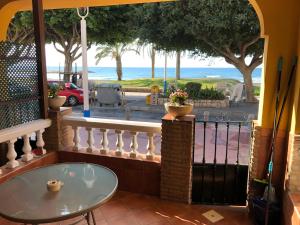 a balcony with a table and a view of the ocean at Apartamentos casa Tia Antonia in Málaga