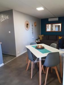 a room with a table and chairs and a couch at Caze bois flotté in Petite Île