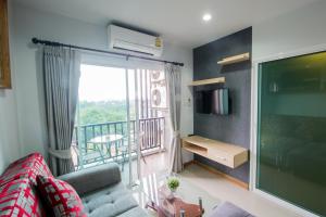 a living room with a couch and a balcony at Aonang Ocean View Studio ( The Sea Condo ) in Ao Nang Beach