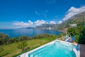 a swimming pool with a view of a lake at Villa Panorama in Praiano
