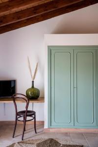 a chair and a cabinet in a room at Curolla Petit Hotel in Maria de la Salut