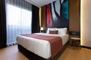 a bedroom with a large bed and a large window at Nox Suite Rezidans in Antalya +72 photos