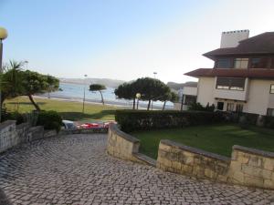 a house with a brick walkway in front of a building at Bay House with pool 1 minute from the beach in São Martinho do Porto