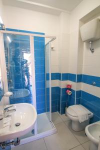 a bathroom with a shower and a toilet and a sink at Hotel Bellavista in Ponza