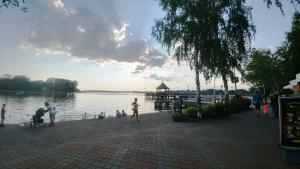 a group of people standing on a pier near the water at Domek Ostróda in Ostróda