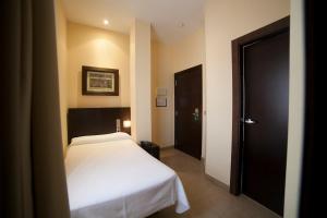 Postel nebo postele na pokoji v ubytování Hotel El Mesón