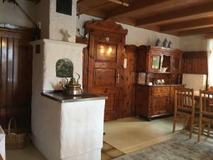 a kitchen with wooden cabinets and a tea kettle on a counter at Haus Sonnleitn in Sankt Johann im Pongau