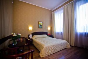 a hotel room with a bed and a table at City Club in Kharkiv