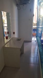a room with a table with two wine glasses on it at Athina Apartments Tolo in Tolo +63 photos