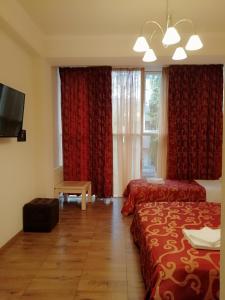 a hotel room with two beds and a window at Guesthouse Aragats in Adler