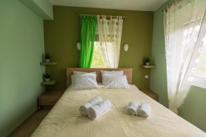 a bedroom with a bed with two towels on it at House Christie in Chrysi Ammoudia