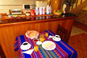 a table with a plate of food on it at Hospedaje Kamila in Cusco