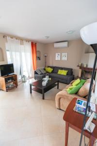 a living room with a couch and a table at House Christie in Chrysi Ammoudia