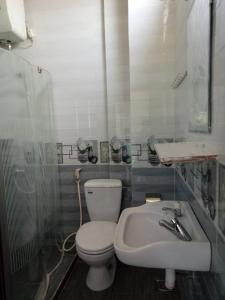 a bathroom with a toilet and a sink at Dong Hai Hotel in Phú Vang