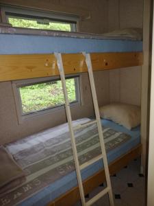 a bunk bed room with two bunk beds and a window at Samson mobile house in Bled