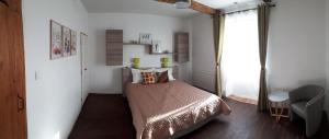 a small bedroom with a bed and a window at Jazz et Vacances in Monlezun