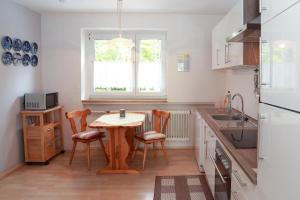 a kitchen with a table and chairs and a window at Ferienwohnung Casa MIA in Spiegelau