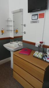 a bathroom with a sink and a counter with a sink at The Oakcliffe in Exeter