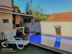 Bazén v ubytování Duplex DE LUX com piscina,Churrasqueira TOTALMENTE PRIVATIVO nebo v jeho okolí
