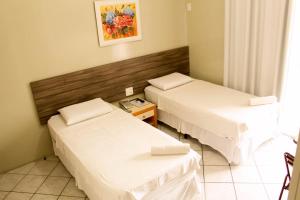 Cama ou camas em um quarto em Vila Rica Hotel Caruaru